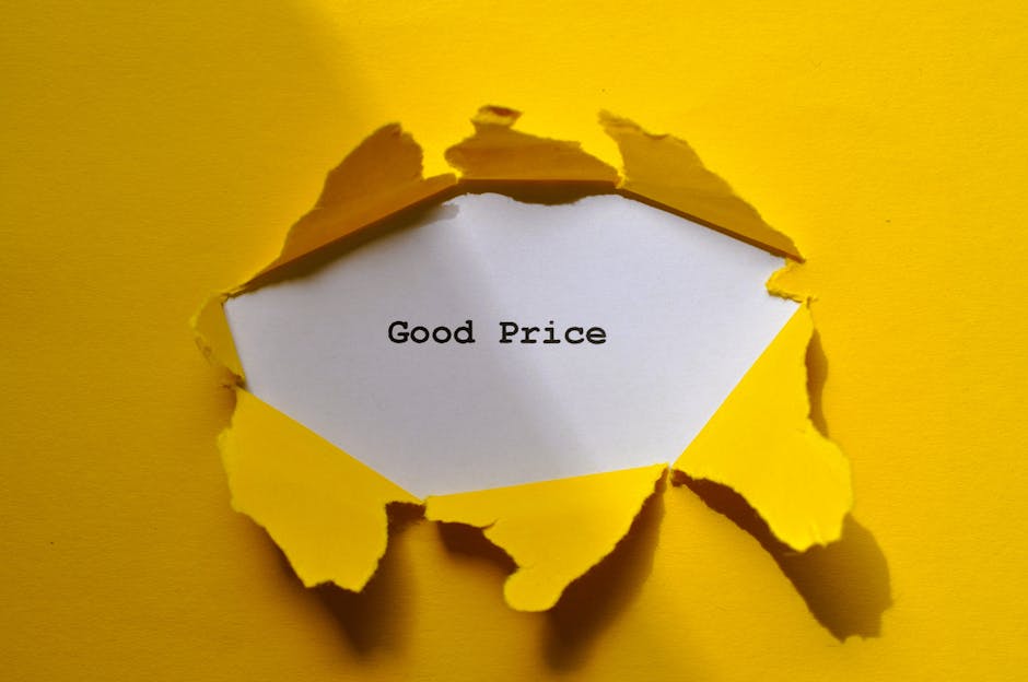 A torn yellow paper with jagged edges reveals a white piece of paper inside, on which the words 'Good Price' are typed in black. The torn yellow paper is set against a plain, bright yellow background,